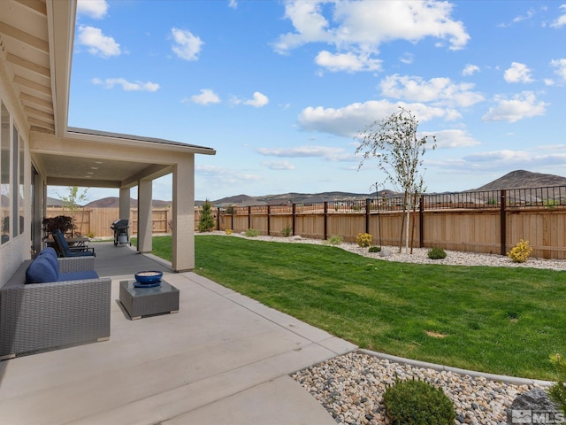 view of yard with a patio area and a mountain view
