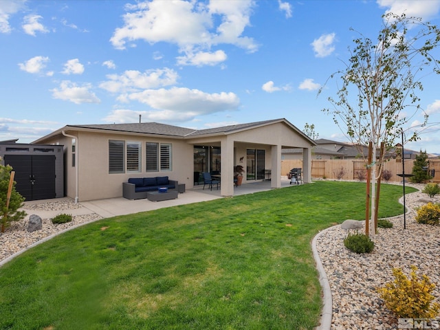 back of property featuring outdoor lounge area, stucco siding, a patio area, a storage shed, and an outdoor structure