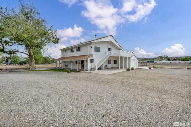 1131 Linda Anne Ct, Gardnerville, NV 89410 - rear view of property with an attached garage, stairs, driveway, and fence