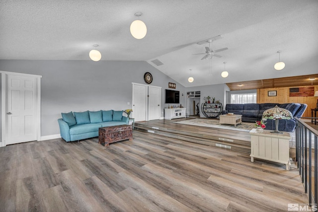 1131 Linda Anne Ct, Gardnerville, NV 89410 - living area with lofted ceiling, ceiling fan, wood finished floors, a textured ceiling, and baseboards