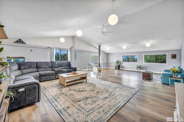 1131 Linda Anne Ct, Gardnerville, NV 89410 - living area featuring a textured ceiling, lofted ceiling, wood finished floors, ceiling fan, and baseboards