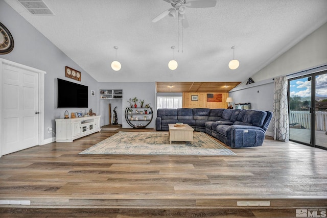 1131 Linda Anne Ct, Gardnerville, NV 89410 - living area featuring a textured ceiling, wood finished floors, a ceiling fan, baseboards, and high vaulted ceiling
