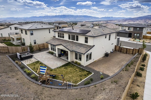 5410 Cactus Quartz Ct, Sparks, NV 89436 - back of property with a residential view, a mountain view, a patio, and solar panels