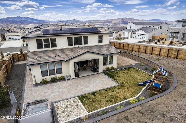 5410 Cactus Quartz Ct, Sparks, NV 89436 - rear view of house featuring stucco siding, a patio area, a mountain view, and a fenced backyard