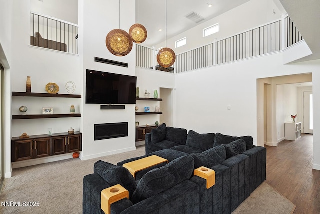 5410 Cactus Quartz Ct, Sparks, NV 89436 - living area with a towering ceiling, a fireplace, wood finished floors, and baseboards