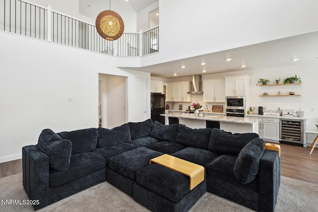 5410 Cactus Quartz Ct, Sparks, NV 89436 - living room featuring wine cooler, wood finished floors, recessed lighting, a towering ceiling, and baseboards