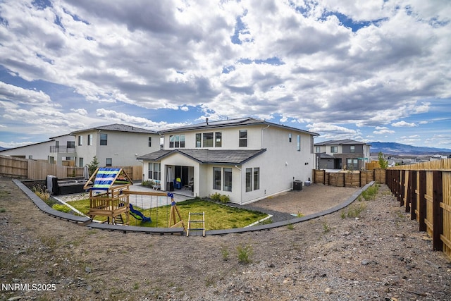 5410 Cactus Quartz Ct, Sparks, NV 89436 - back of house featuring a patio, a fenced backyard, roof mounted solar panels, and stucco siding