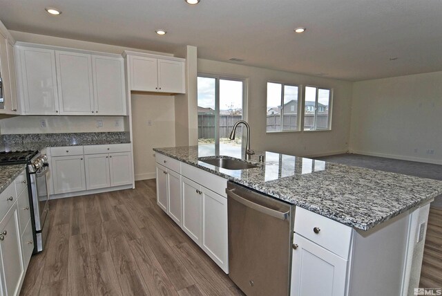 2091 Forest Grove Ln, Sparks, NV 89436 - kitchen with appliances with stainless steel finishes, a sink, white cabinets, dark wood-type flooring, and recessed lighting