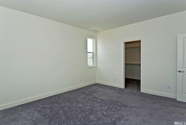 2091 Forest Grove Ln, Sparks, NV 89436 - unfurnished bedroom featuring dark carpet, baseboards, and a spacious closet