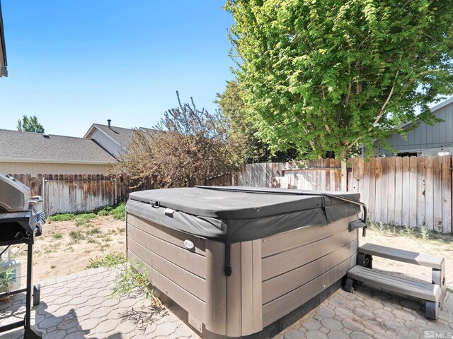 1466 Edlesborough Cir, Gardnerville, NV 89410 - wooden deck with a hot tub, a fenced backyard, and a patio
