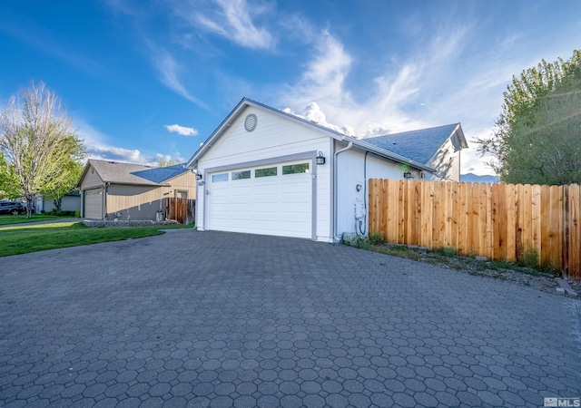 1466 Edlesborough Cir, Gardnerville, NV 89410 - view of front of house with fence, an attached garage, and decorative driveway