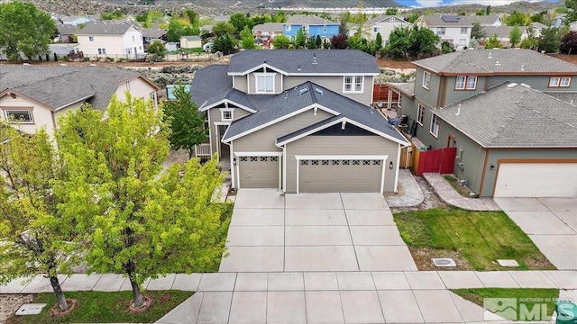 8952 Mahon Dr, Reno, NV 89506 - view of front of house with a residential view, driveway, fence, and an attached garage
