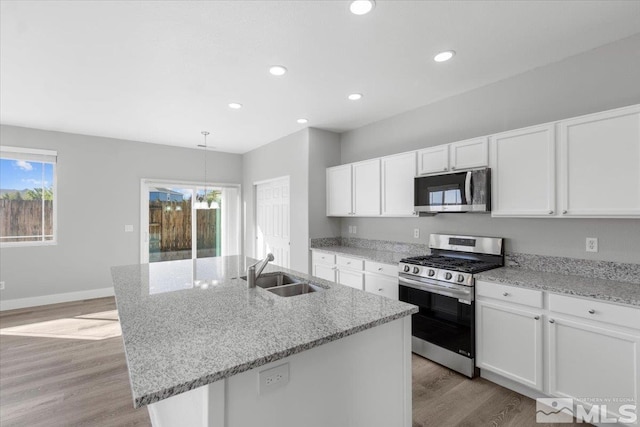 8952 Mahon Dr, Reno, NV 89506 - kitchen featuring stainless steel appliances, a sink, light wood-style flooring, white cabinets, and recessed lighting
