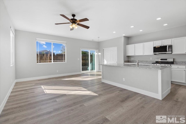 8952 Mahon Dr, Reno, NV 89506 - kitchen featuring stainless steel appliances, recessed lighting, light wood-type flooring, white cabinets, and baseboards