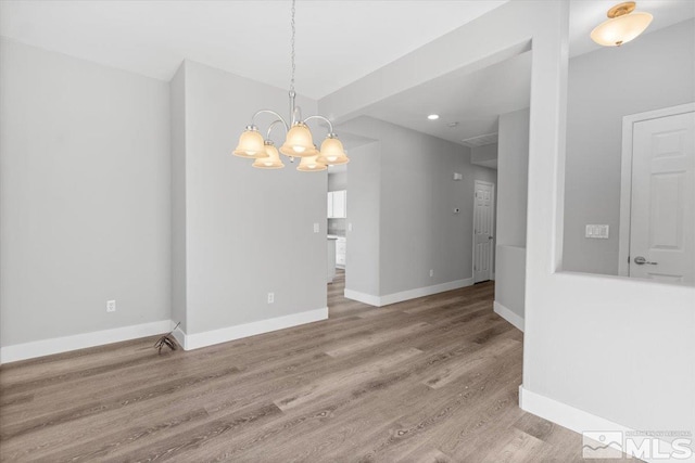 8952 Mahon Dr, Reno, NV 89506 - empty room with a chandelier, wood finished floors, recessed lighting, and baseboards