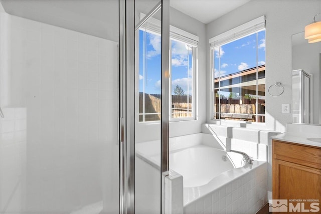 8952 Mahon Dr, Reno, NV 89506 - bathroom with vanity, a bath, and a shower stall