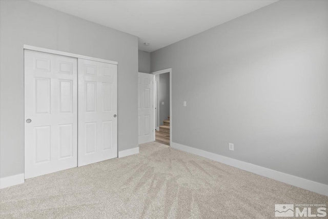 8952 Mahon Dr, Reno, NV 89506 - unfurnished bedroom with carpet flooring, a closet, and baseboards