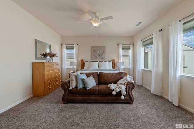 carpeted bedroom featuring baseboards and a ceiling fan