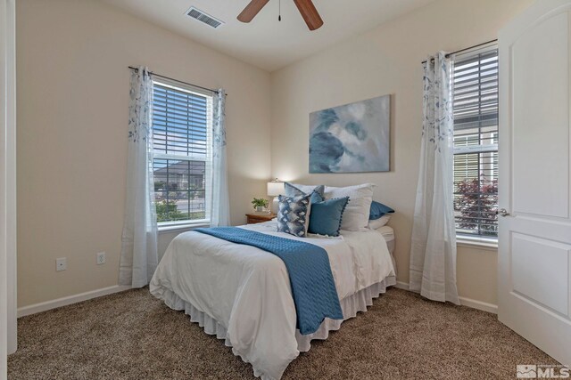 bedroom with multiple windows, carpet floors, and baseboards