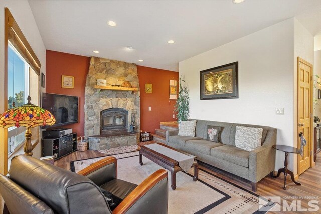 2045 Flint Rd, Reno, NV 89521 - living area with wood finished floors, recessed lighting, and a stone fireplace