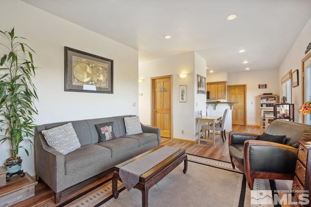 living room with light wood-style floors and recessed lighting