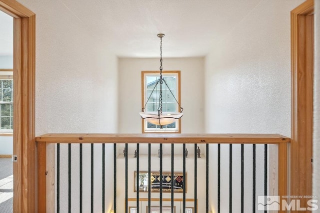detailed view of a chandelier and a textured wall
