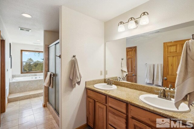 2045 Flint Rd, Reno, NV 89521 - full bathroom with a shower stall, tile patterned floors, double vanity, and a garden tub
