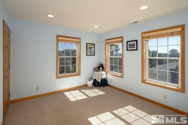 carpeted empty room with baseboards and recessed lighting