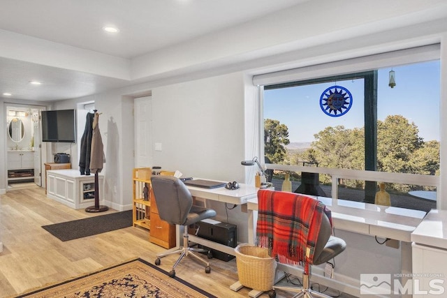 office featuring light wood-style floors, baseboards, and recessed lighting