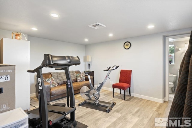 workout room with light wood finished floors, recessed lighting, and baseboards