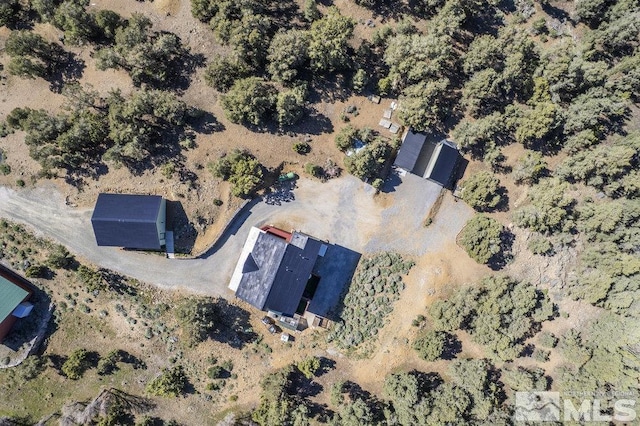 aerial view of property and surrounding area featuring a desert landscape