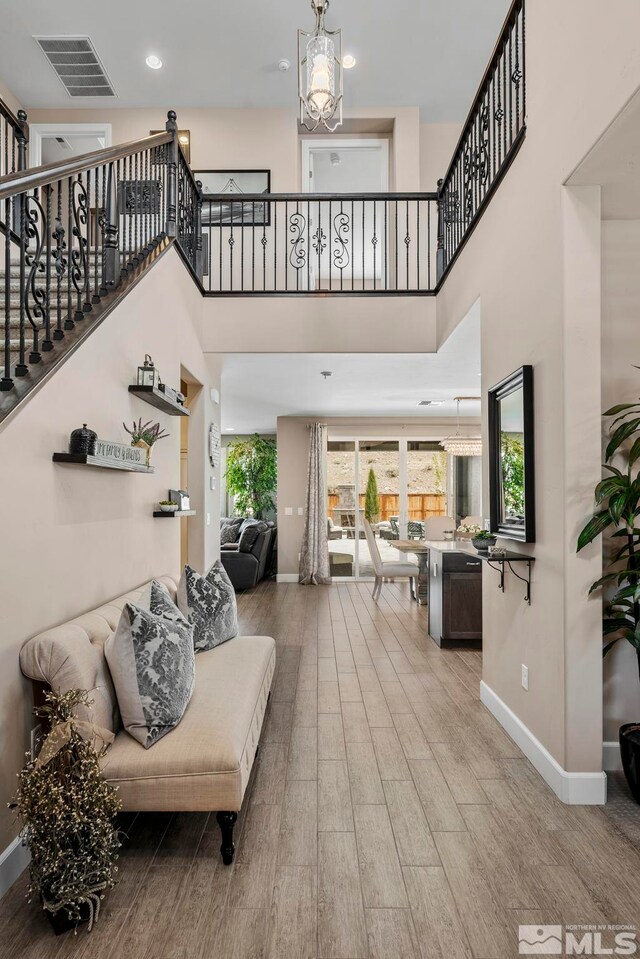 3325 Show Jumper Ln, Reno, NV 89521 - living area featuring baseboards, wood finished floors, stairs, and a high ceiling