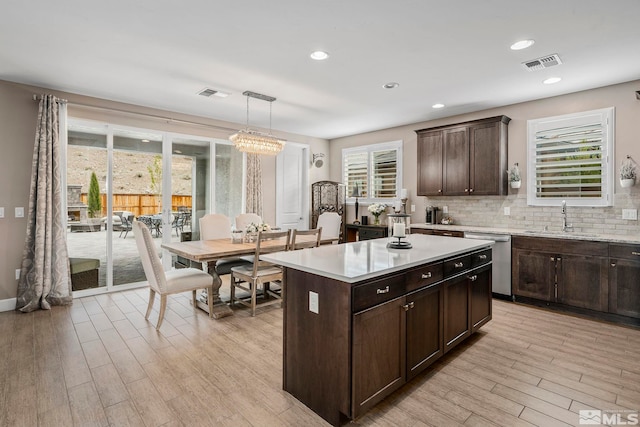 3325 Show Jumper Ln, Reno, NV 89521 - kitchen with stainless steel dishwasher, a sink, light wood-style flooring, light countertops, and recessed lighting