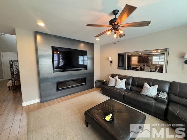3325 Show Jumper Ln, Reno, NV 89521 - living area with a large fireplace, wood finished floors, a ceiling fan, baseboards, and recessed lighting