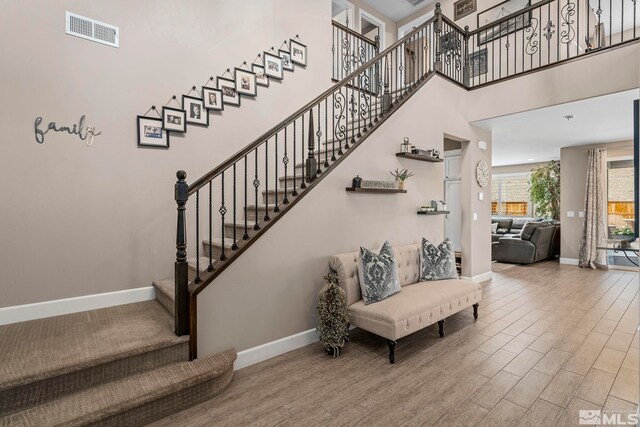 3325 Show Jumper Ln, Reno, NV 89521 - stairs featuring baseboards, wood finished floors, and a high ceiling