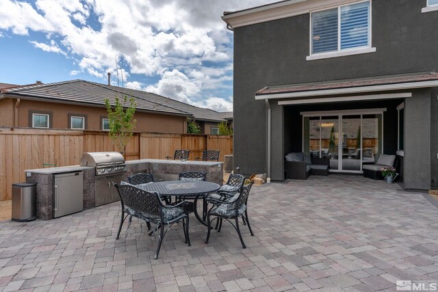 3325 Show Jumper Ln, Reno, NV 89521 - view of patio with grilling area, fence, an outdoor kitchen, french doors, and outdoor dining space
