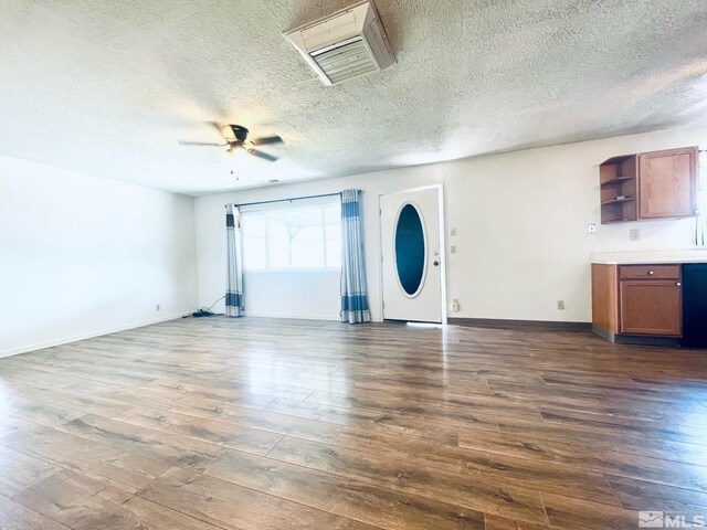 220 Pamela Dr, Walker Lake, NV 89415 - unfurnished living room featuring dark wood-style floors, a ceiling fan, a textured ceiling, and baseboards