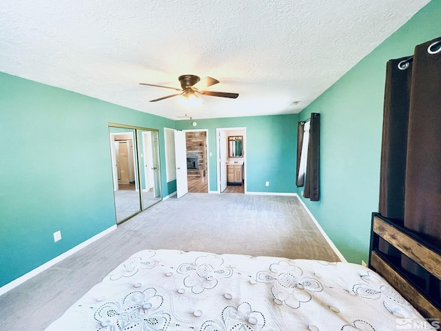 220 Pamela Dr, Walker Lake, NV 89415 - unfurnished bedroom featuring carpet, ensuite bathroom, a fireplace, baseboards, and a textured ceiling