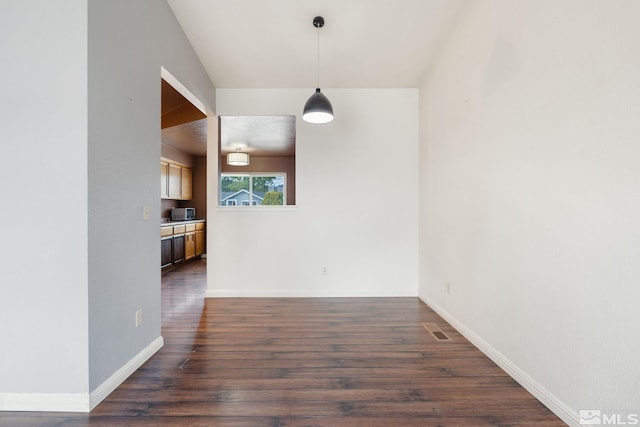 123 River Village Cir, Dayton, NV 89403 - unfurnished dining area with baseboards and dark wood-type flooring
