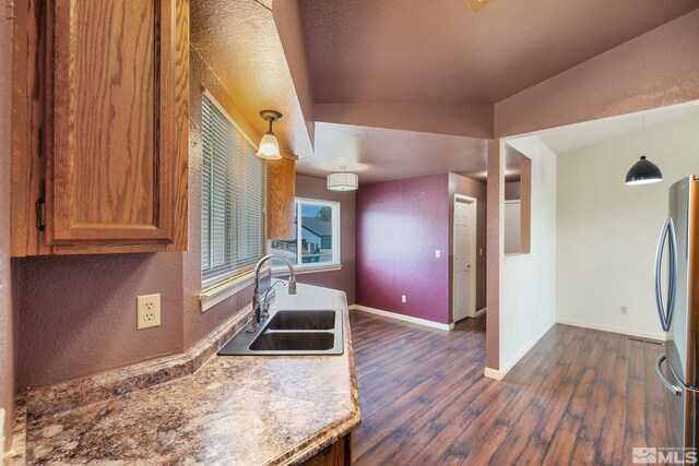123 River Village Cir, Dayton, NV 89403 - kitchen featuring a sink, freestanding refrigerator, brown cabinetry, dark wood finished floors, and baseboards