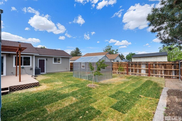 123 River Village Cir, Dayton, NV 89403 - view of yard featuring a greenhouse, an outdoor structure, a wooden deck, and central AC unit