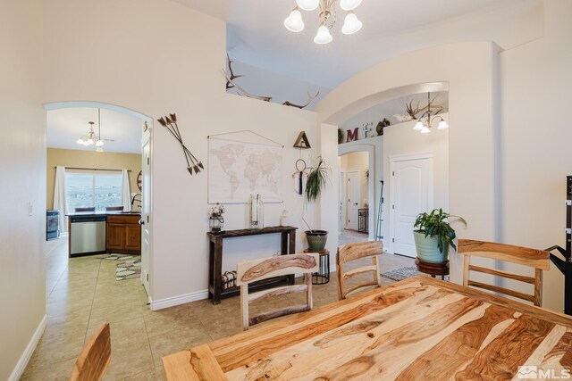 748 Thistle Dr, Spring Creek, NV 89815 - dining space with a chandelier, arched walkways, light tile patterned floors, lofted ceiling, and baseboards