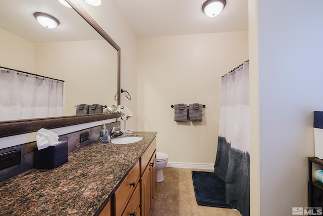 748 Thistle Dr, Spring Creek, NV 89815 - full bathroom with vanity, toilet, baseboards, and a shower with curtain