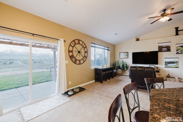 748 Thistle Dr, Spring Creek, NV 89815 - living room with lofted ceiling, a ceiling fan, light colored carpet, light tile patterned floors, and baseboards