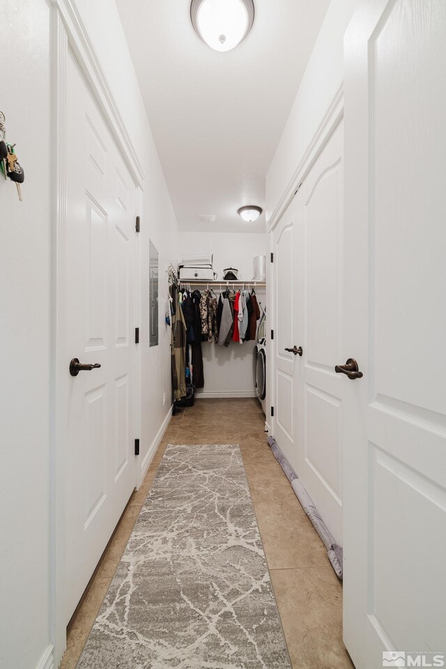 748 Thistle Dr, Spring Creek, NV 89815 - hallway with washer / dryer and light tile patterned flooring