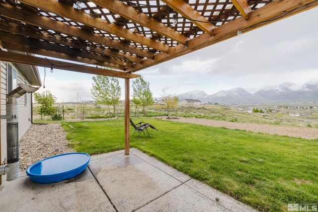 748 Thistle Dr, Spring Creek, NV 89815 - view of patio featuring a mountain view and a pergola