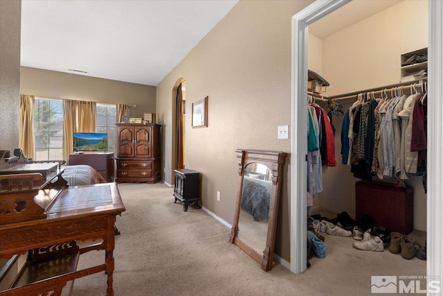 10010 Purple Sage Dr, Reno, NV 89506 - bedroom with a closet, light carpet, baseboards, and arched walkways