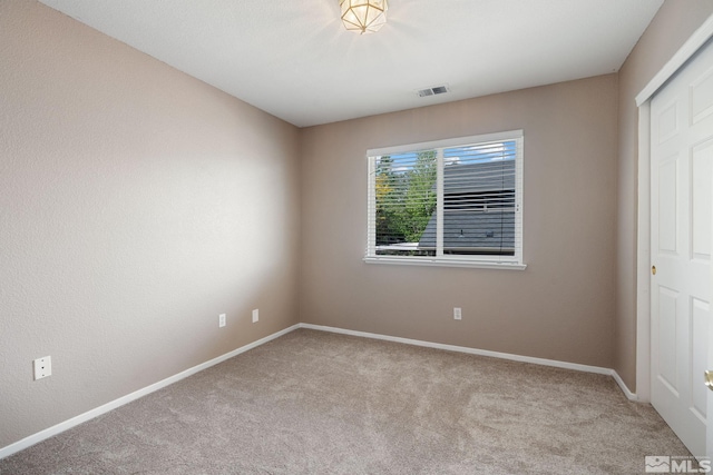 empty room with carpet flooring and baseboards