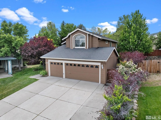 traditional-style house with concrete driveway, an attached garage, and roof with shingles