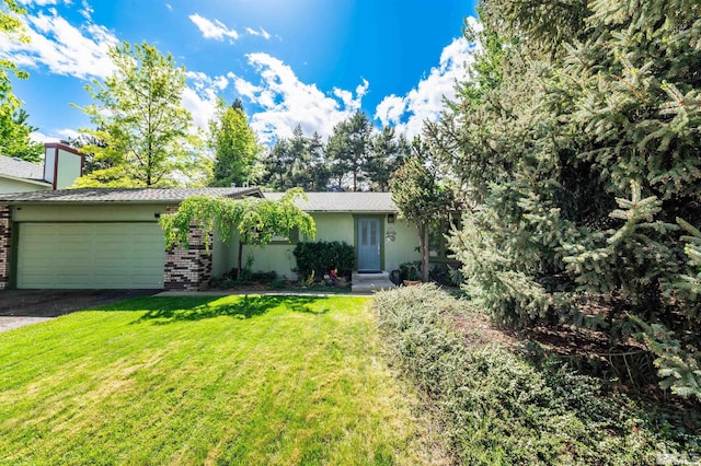 12565 Creek Crest Dr, Reno, NV 89511 - view of front facade with an attached garage, a front lawn, driveway, brick siding, and stucco siding
